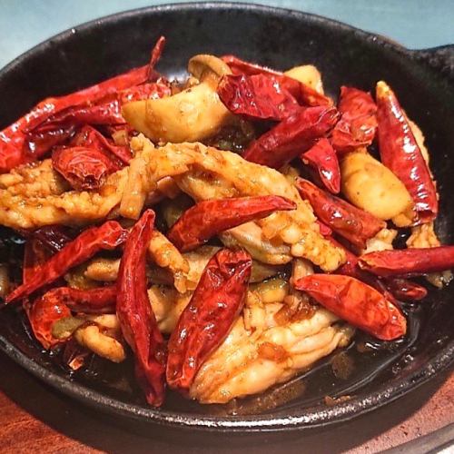 Super spicy chicken breast and king oyster mushrooms on a hot plate