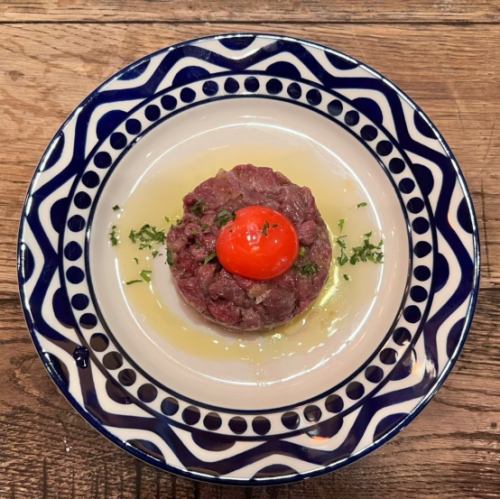Cherry meat tartare topped with rich egg