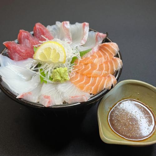 Bowl of rice topped with sashimi