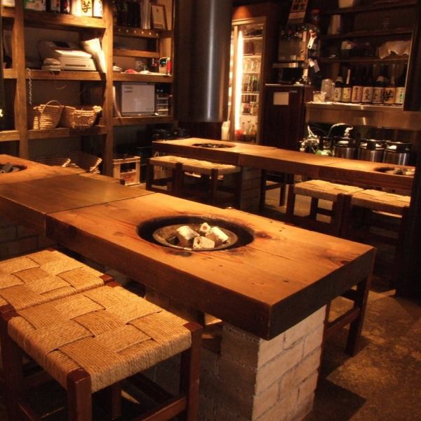 【1階/テーブル席】自然な会話が楽しめるよう、あえて低めに設計されたテーブル席。日本の文化を活かした和の落ち着いた雰囲気が自慢です。食後は炭火を見ながらゆっくりと落ち着いた時間を過ごせます。