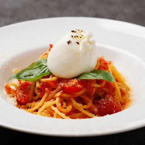 Fresh tomato pasta topped with burrata cheese