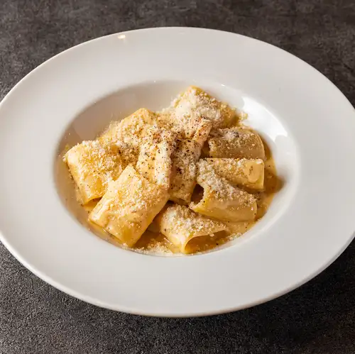 Rich cheese carbonara with paccheri pasta