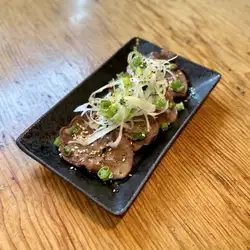 Thinly sliced beef tongue with green onions and salt