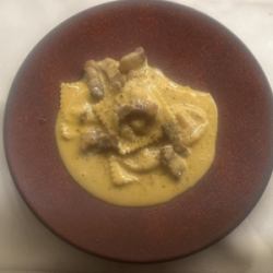 Ricotta cheese and modern ravioli with platinum pork bacon and egg yolk cream sauce