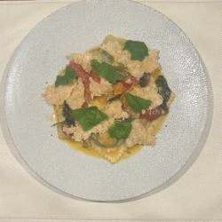 Cold-cured spinach and orange-scented homemade ricotta cheese ravioli with crispy Parmesan and fresh tomato sauce