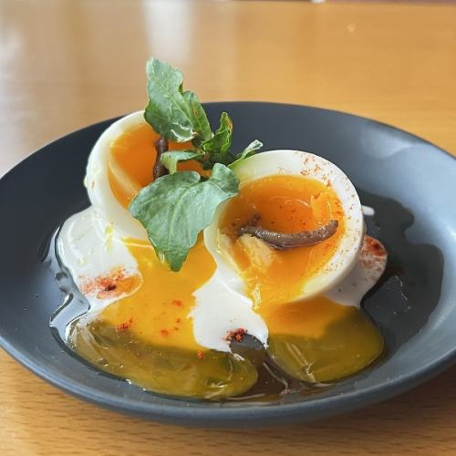 Soft-boiled egg topped with anchovies