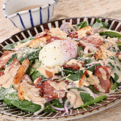 Caesar salad with soft-boiled egg and bacon