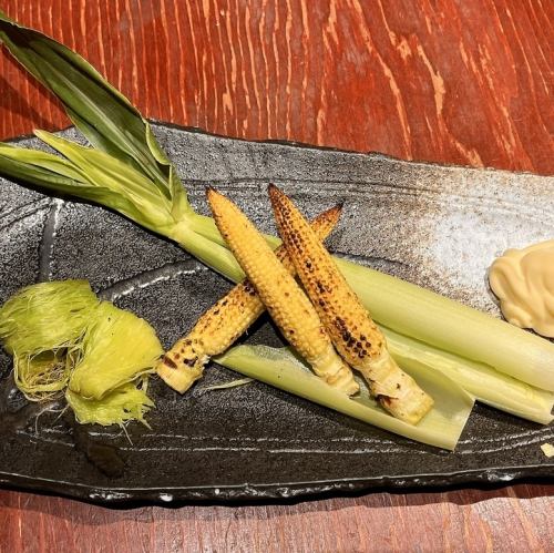 Grilled baby corn over charcoal
