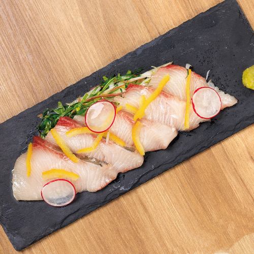 Yellowtail sashimi served with flavored vegetables