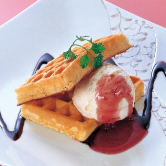 Brown waffles with strawberry and chocolate sauce