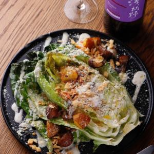 Lyonnaise salad with grilled whole romaine lettuce and Iberian bacon