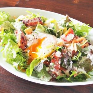 Caesar salad with thick-sliced bacon and warm egg