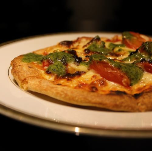 Pizza with fresh tomatoes and homemade basil sauce