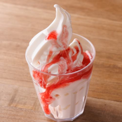 Soft serve ice cream with strawberry sauce