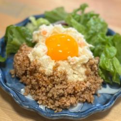 Homemade potato salad with minced meat and egg yolk