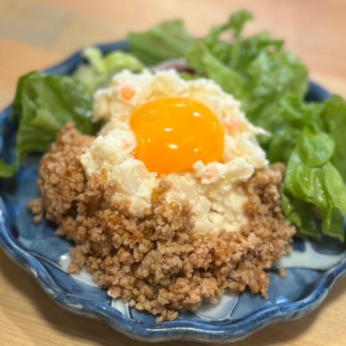 Homemade potato salad with minced meat and egg yolk