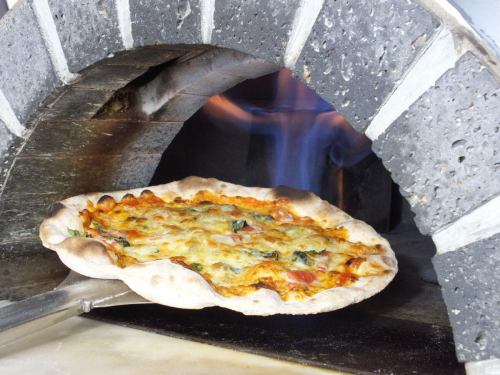 A stone oven with black and white tiles.