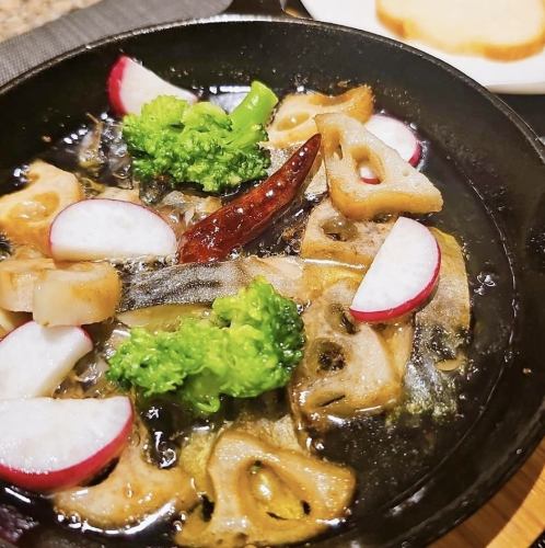 Mackerel and lotus root ajillo with a bucket