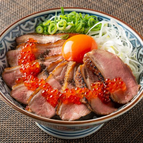 Specialty seared duck rice bowl topped with salmon roe