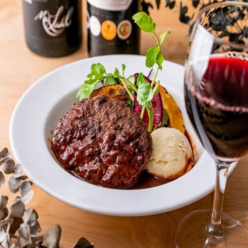 Hand-made beef hamburger steak on lava rocks - served with grilled Yokohama vegetables