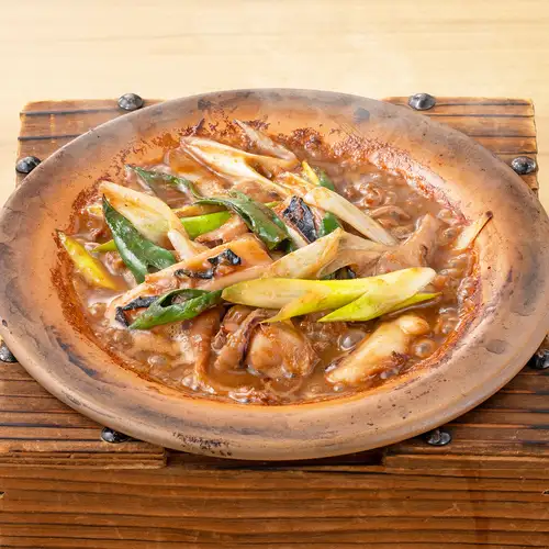 Grilled squid guts on a ceramic plate