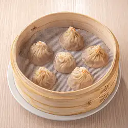 Six crab roe-filled xiao long bao (soup dumplings).