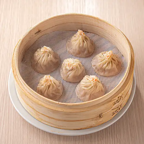 Six crab roe-filled xiao long bao (soup dumplings).