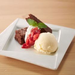 Chocolate brownie & milk ice cream with strawberry sauce