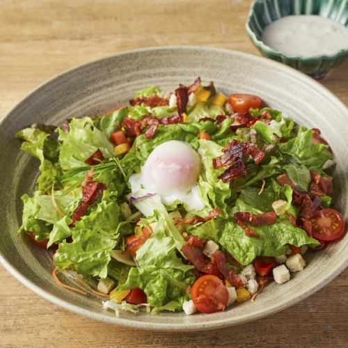 Caesar salad with soft-boiled egg and bacon