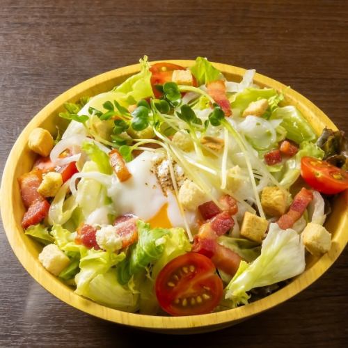 Caesar salad with soft-boiled egg and bacon