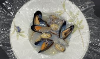 Steamed mussels and clams in white wine wrapped in Carta Fata