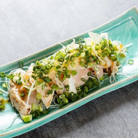 Seared local chicken thigh covered in green onions