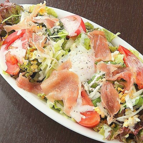 Caesar salad with hot egg and prosciutto