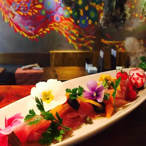 Tuna and salmon carpaccio with salted kelp and pickled eggplant.