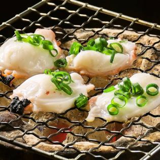 Live octopus grilled on a charcoal grill