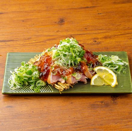 Seared chicken breast covered in green onions