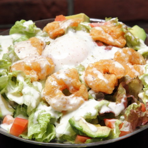 Hot shrimp, avocado, tomato and warm egg Caesar salad (S) - topped with 24-month aged Parmesan cheese