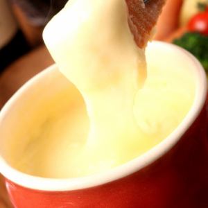 Cheese fondue with steaming potatoes