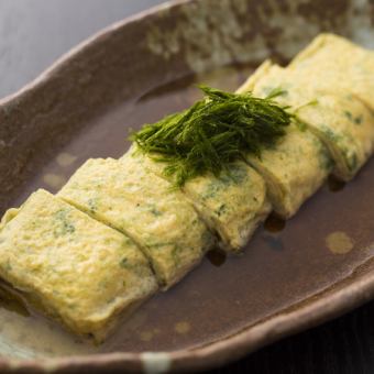 Dashi rolled egg with green seaweed