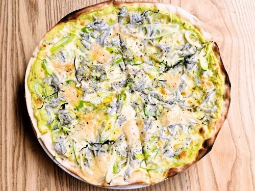 Cream pizza with whitebait, fava beans, and parmesan cheese