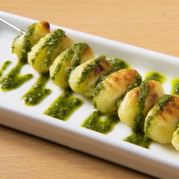 Iron skewered gnocchi topped with genovese