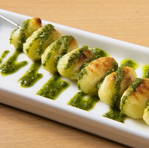 Iron skewered gnocchi with Genovese sauce