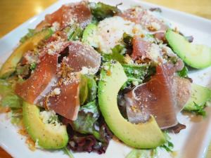 Prosciutto and avocado Caesar salad with hot egg