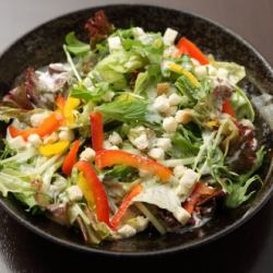 Crispy Caesar salad with colorful vegetables and fried burdock