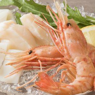 Assortment of 3 seafood items (shrimp, squid, scallops)