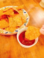 Nacho chips with spicy ketchup dipping