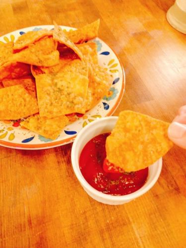 Nacho chips with spicy ketchup dipping