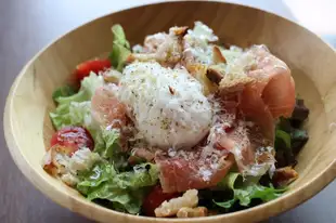Caesar-style salad with prosciutto and poached egg.