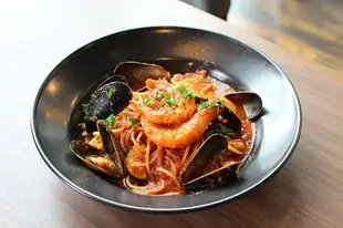 Shrimp and mussels in tomato sauce with basil
