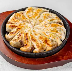 [Piping Hot] 15 bite-sized dumplings served on a hot plate.